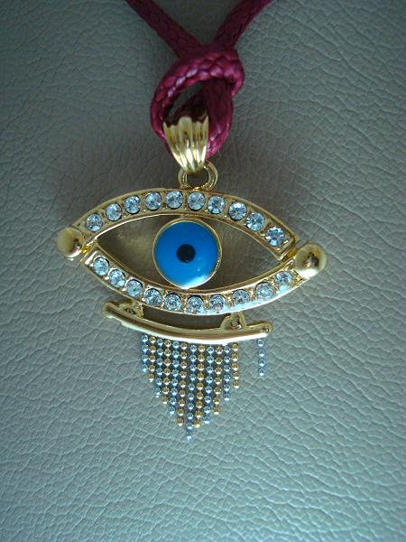 Blue eye brass pendant with zircon stones.